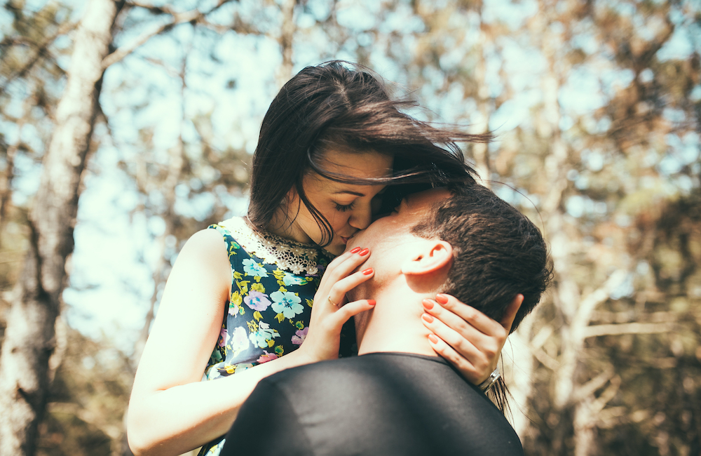 young couple kissing outside